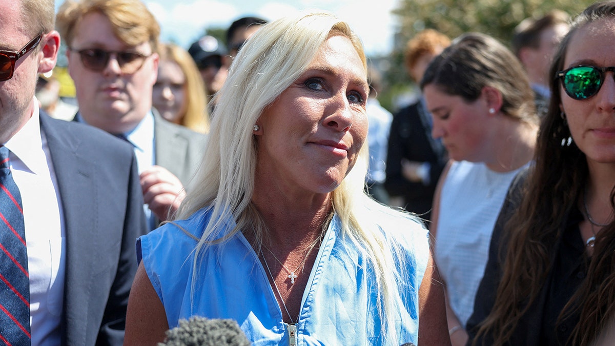 Rep. Marjorie Taylor Greene talks to reporters