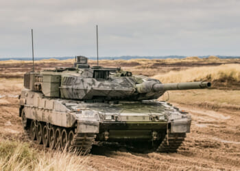 A Leopard 2 armored tank in terrain.