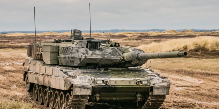 A Leopard 2 armored tank in terrain.