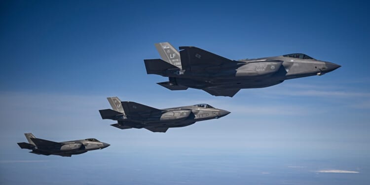 Three F-35 fighter jets in flight.