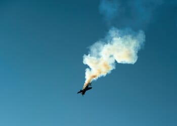 An airplane leaving a smoke trail at an airshow.