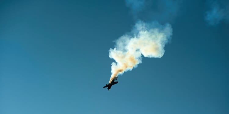 An airplane leaving a smoke trail at an airshow.
