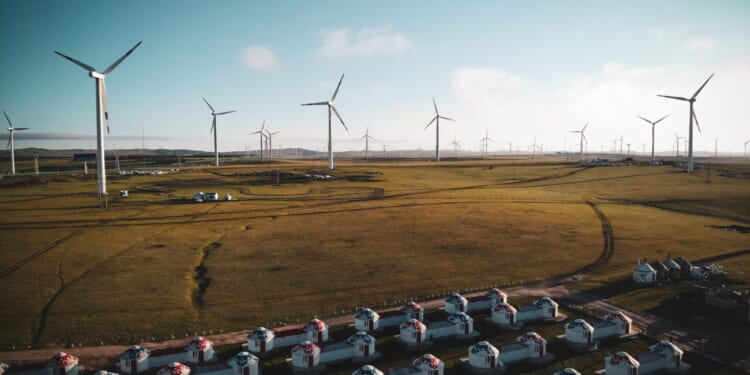 Windmills turn on Mongolian plain.