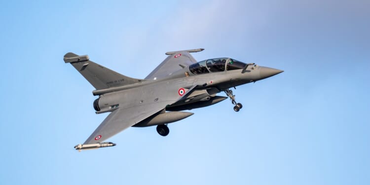 A Dassault Rafale landing at an airfield.