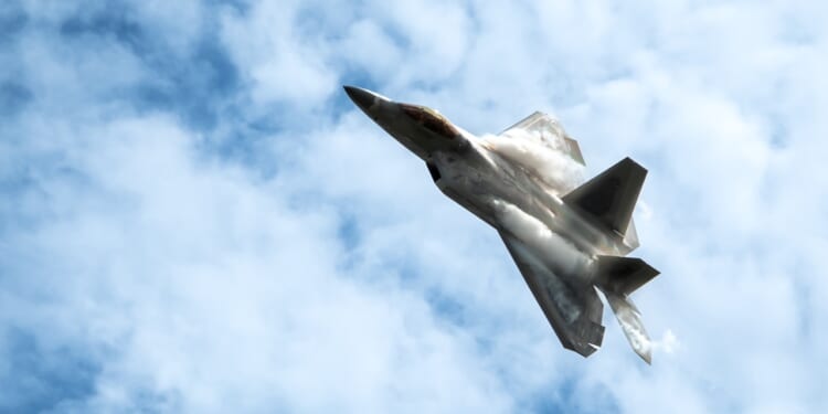 An F-22 Raptor performing an aerial maneuver.