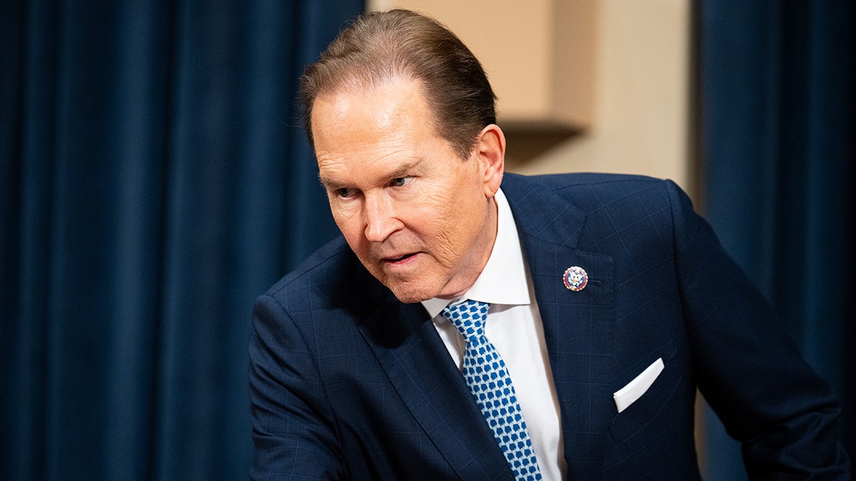 Congressman Vern Buchanan leans over a desk