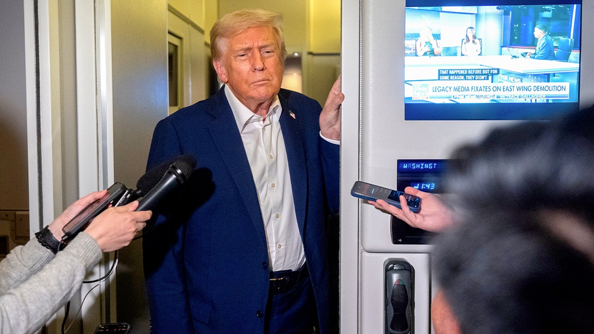 Trump speaks to reporters aboard Air Force One