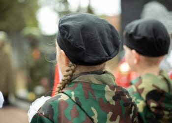 Children in military uniform in Russia.