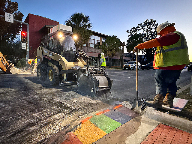 Crews and construction machinery work on the removal of an emblematic rainbow crosswalk in the progressive Montrose neighborhood in Houston, Texas, on October 20, 2025, following state and federal orders. Texas Governor Greg Abbott said he would withhold road funding from cities if they do not remove "political ideologies" from their streets after the Trump administration considered rainbow crosswalks a distraction. (Photo by Moisés ÁVILA / AFP)