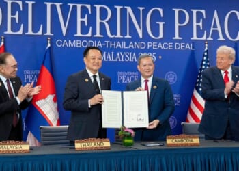The leaders of Thailand and Cambodia signing a peace deal. Donald Trump to one side.