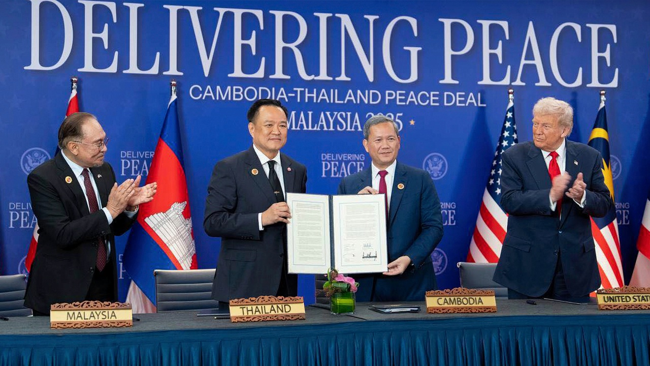 The leaders of Thailand and Cambodia signing a peace deal. Donald Trump to one side.