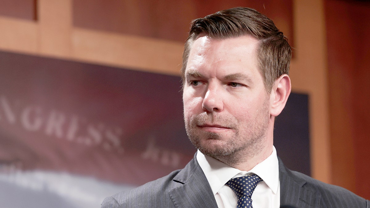 Rep. Eric Swalwell listens during press conference