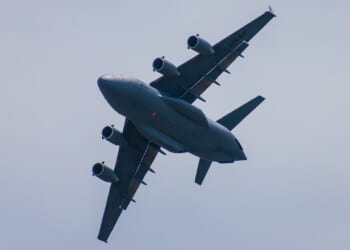 A C-17 Globemaster III cargo plane in flight.