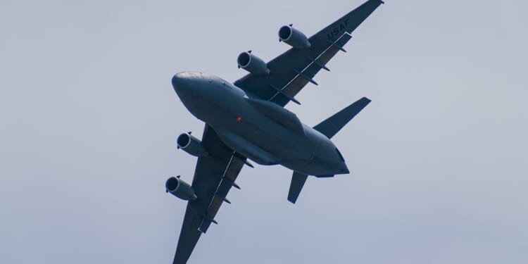 A C-17 Globemaster III cargo plane in flight.