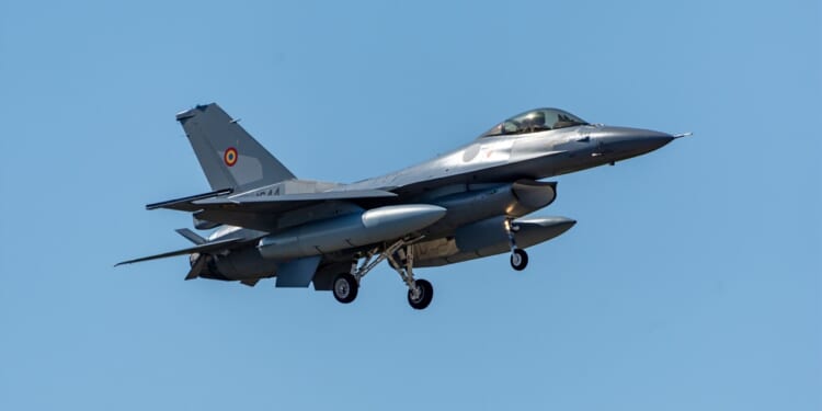 A Romanian F-16 fighter jet in flight.