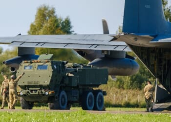 A HIMARS vehicle leaving a plane.