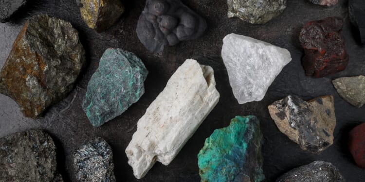 Mixture of critical minerals (United States of America definition), or critical raw materials (European Union definition). Flatlay on slate background