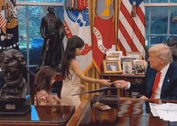 Children accept challenge coins from President Trump in the Oval Office.