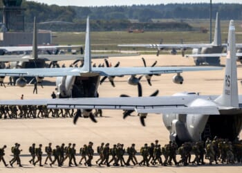 US soldiers boarding a C-130 Hercules plane.