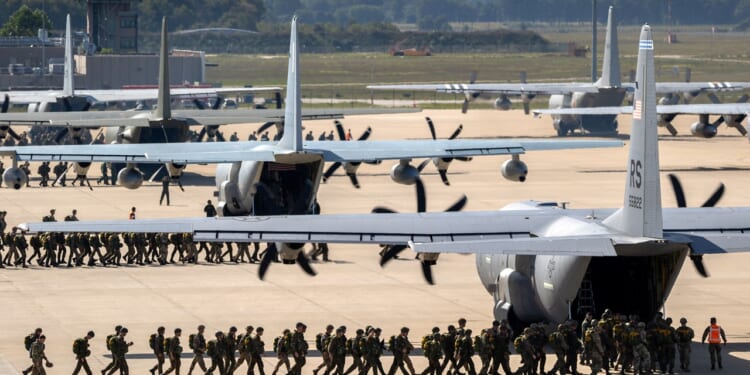 US soldiers boarding a C-130 Hercules plane.