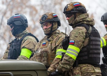 A group of Russian soldiers mounted on a truck.