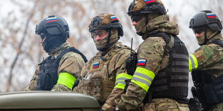 A group of Russian soldiers mounted on a truck.