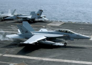 An F/A-18 Super Hornet taking off from an aircraft carrier.