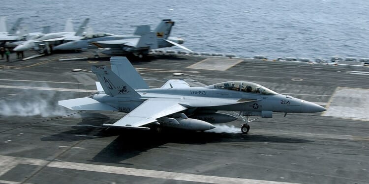 An F/A-18 Super Hornet taking off from an aircraft carrier.