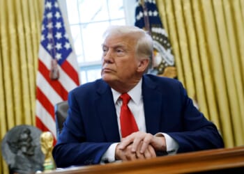 President Donald Trump reflects in the Oval Office.