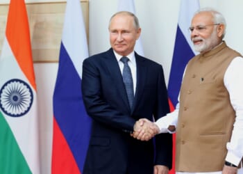 Russian president Vladimir Putin shakes hands with Indian prime minister Narendra Modi.