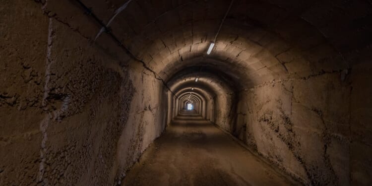 A dimly-lit underground tunnel.