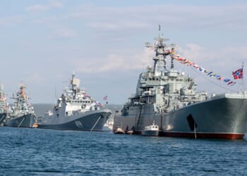 A line of Russian Navy ships in a parade.