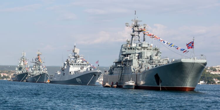 A line of Russian Navy ships in a parade.