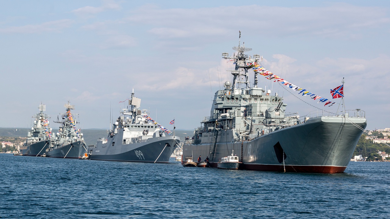 A line of Russian Navy ships in a parade.