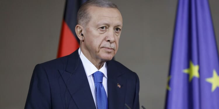 Turkish president Recep Erdogan appears at conference in Berlin.