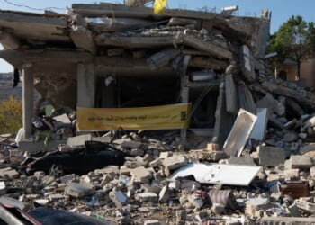 Ruin of a house in Lebanon with Hezbollah flag.