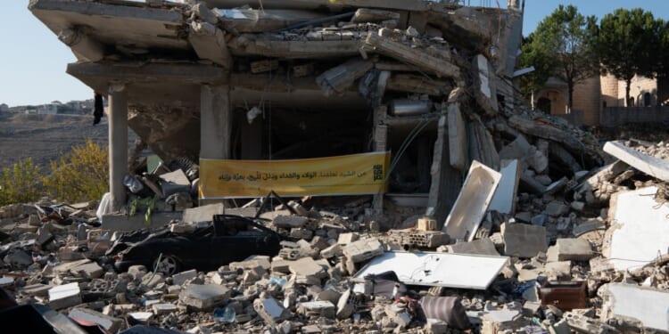 Ruin of a house in Lebanon with Hezbollah flag.