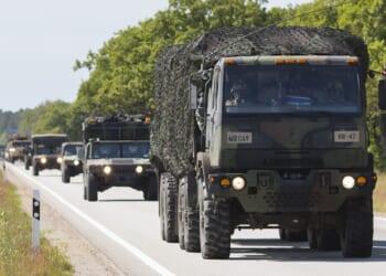 Military vehicles on a road.