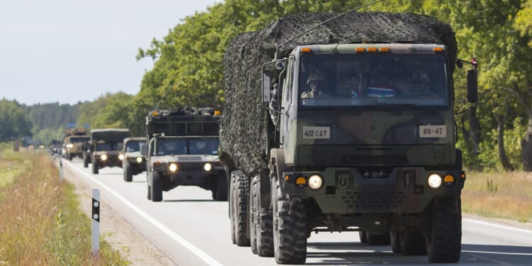 Military vehicles on a road.