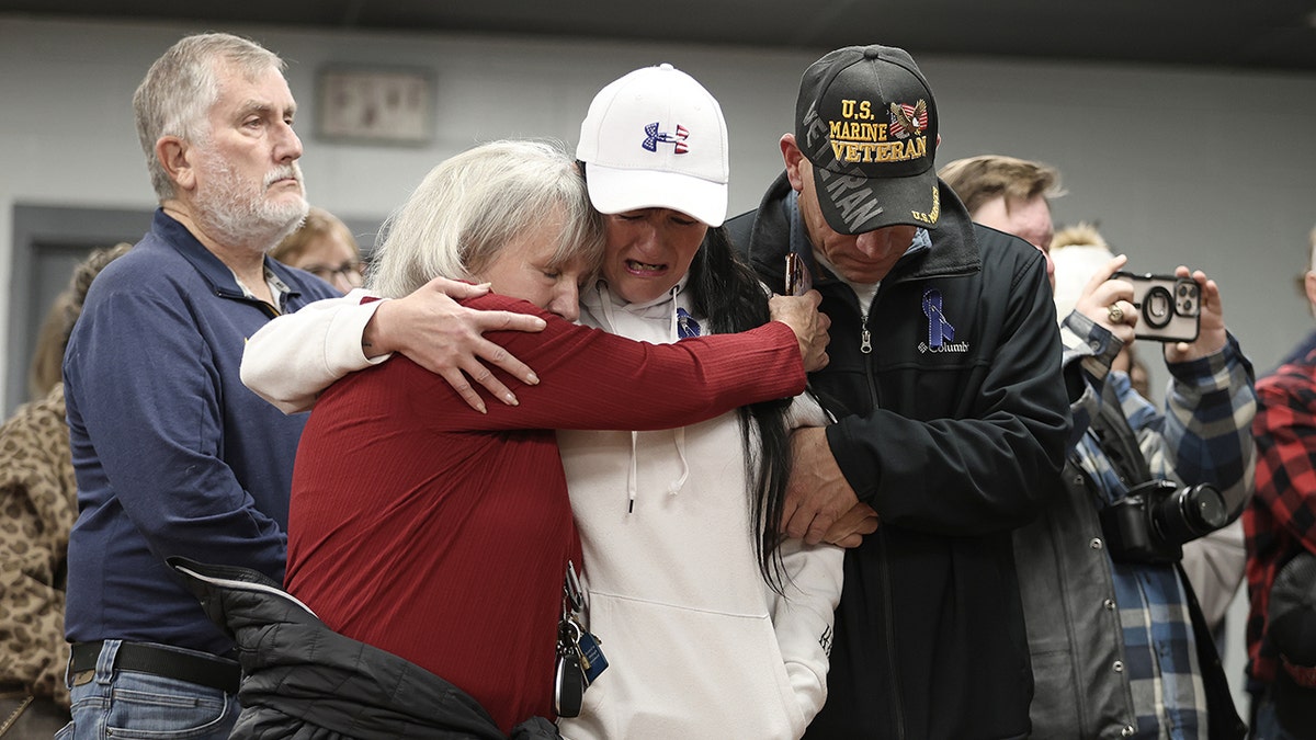 People embrace during vigil for National Guard shooting victim