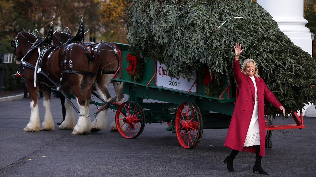 First lady Jill Biden waves after she receives the official White House Christmas Tree on the North Portico of the White House Nov. 22, 2021, in Washington.