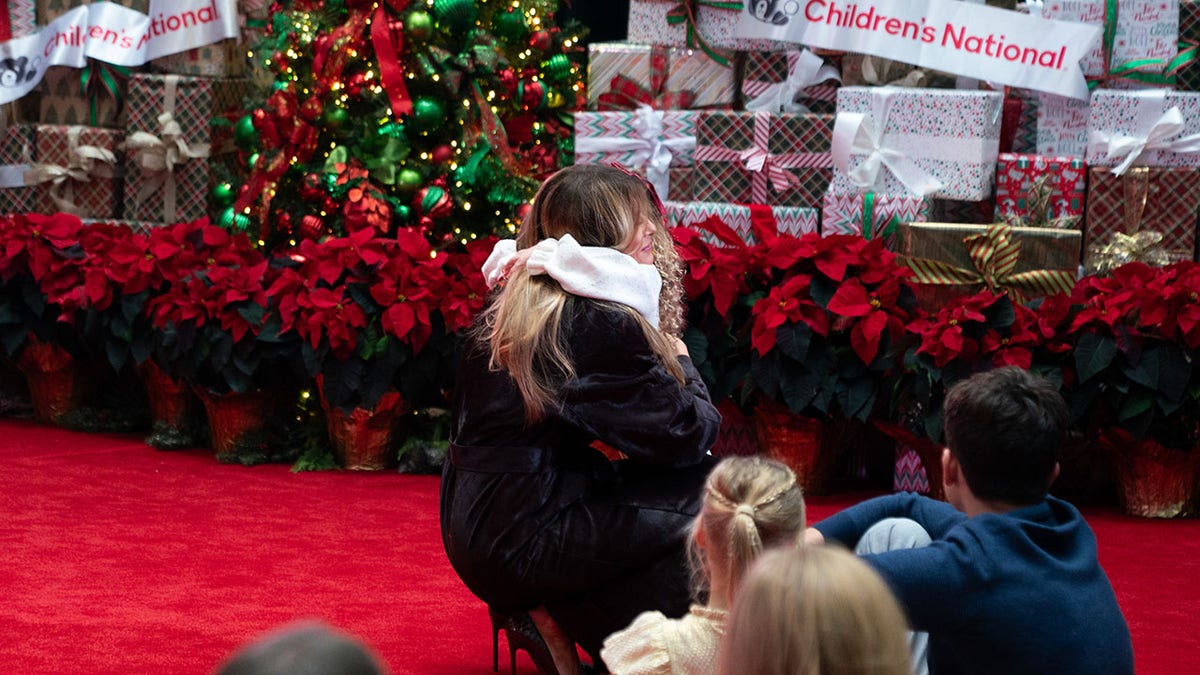 Melania Trump hugging a child