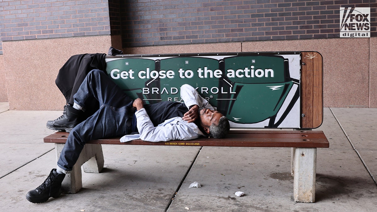 Man sleeps on a public bench in Minneapolis