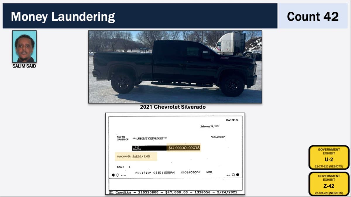 Black 2021 Chevy Silverado shown in DOJ exhibit next to the $47,000 check used to purchase it.