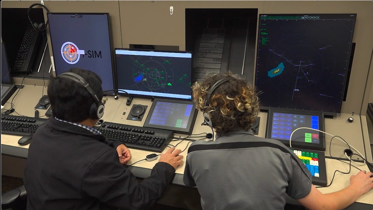An instructor guides a student through a radar simulation showing aircraft movements.