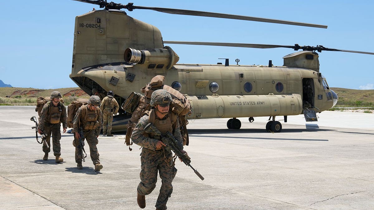 Military troops near helicopter