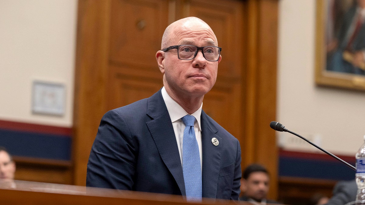Federal aviation official listens attentively during a congressional hearing.