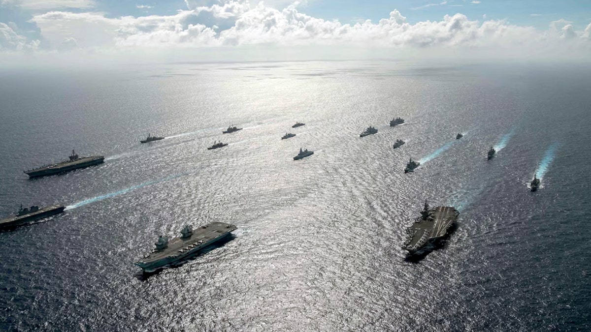 USS Ronald Reagan (CVN 76), USS Carl Vinson (CVN 70), HMS Queen Elizabeth (R 08), and JS Ise (DDH 182) lead a formation during multiple carrier strike group operations, Oct. 3.