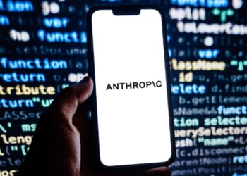 obile phone with website of US artificial intelligence AI company Anthropic PBC on screen in front of logo. Focus on top-left of phone display.