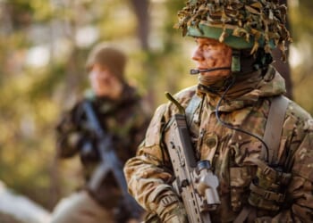 British special forces soldier with weapon take part in military maneuver. war, army, technology and people concept.